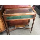 A Mahogany display cabinet with a hinged glass top