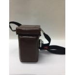 A rolleiflex leather cased camera.