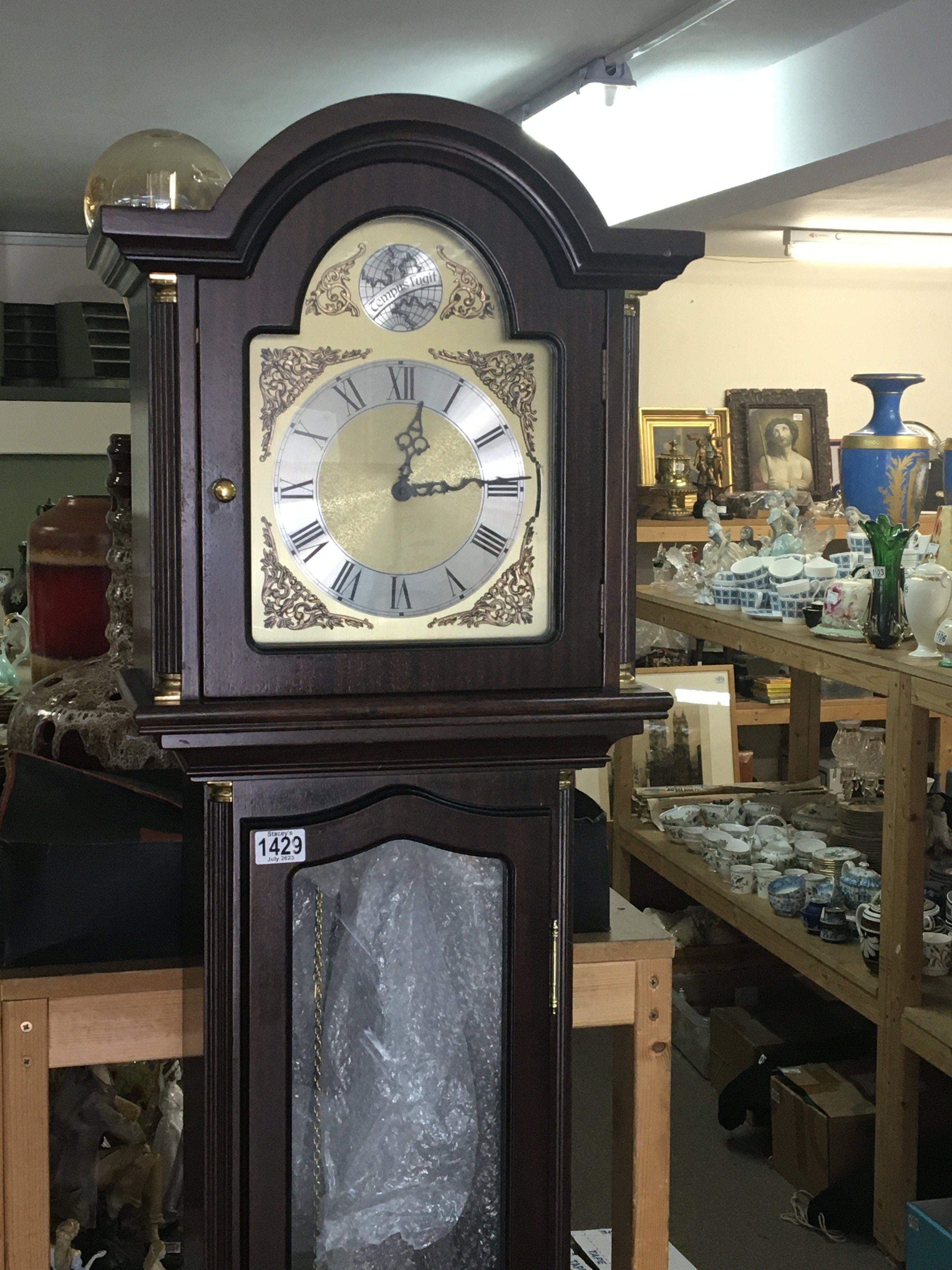 A Mahogany long case clock with three visible weig