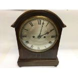 A mahogany mantle clock. Winds but not seen runnin