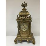 A large brass cased Victorian mantel clock with a