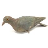 An antique carved and painted pigeon. Postage cat