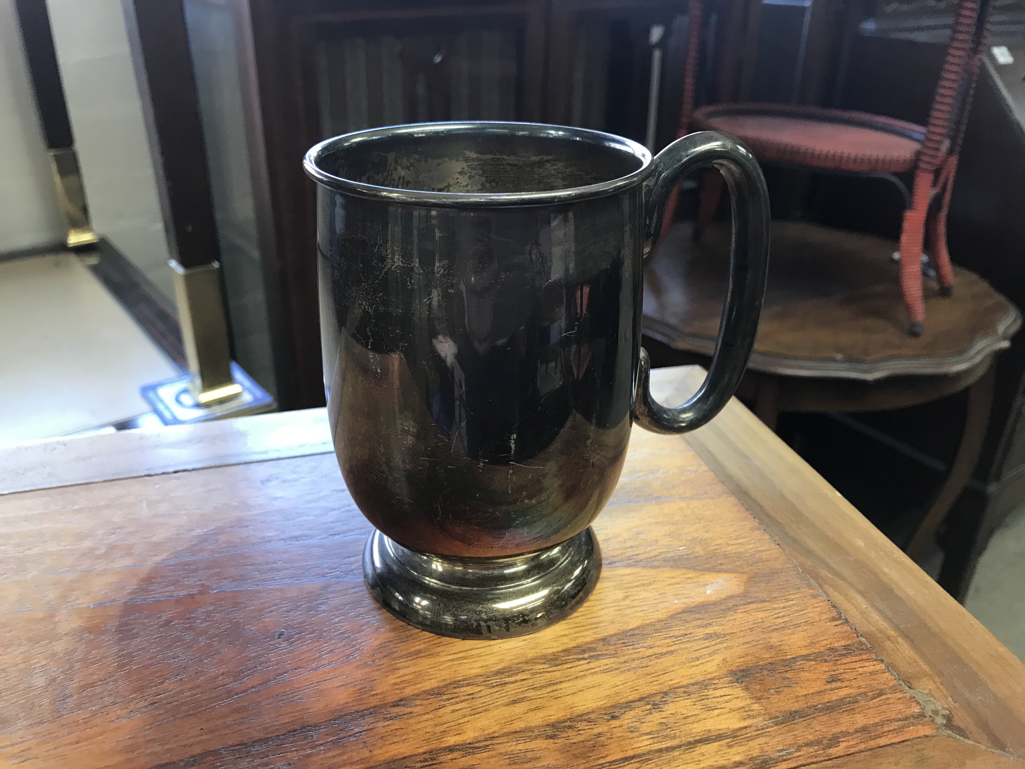 A silver tankard marked with Sheffield hall marks.