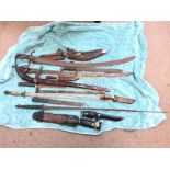 A collection of old swords and knifes including a