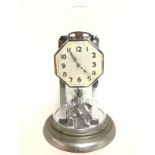 A Chrome art deco design anniversary clock under a