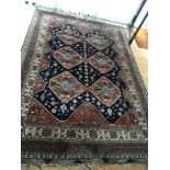 A hand knotted rug with a geometric lozenge patter