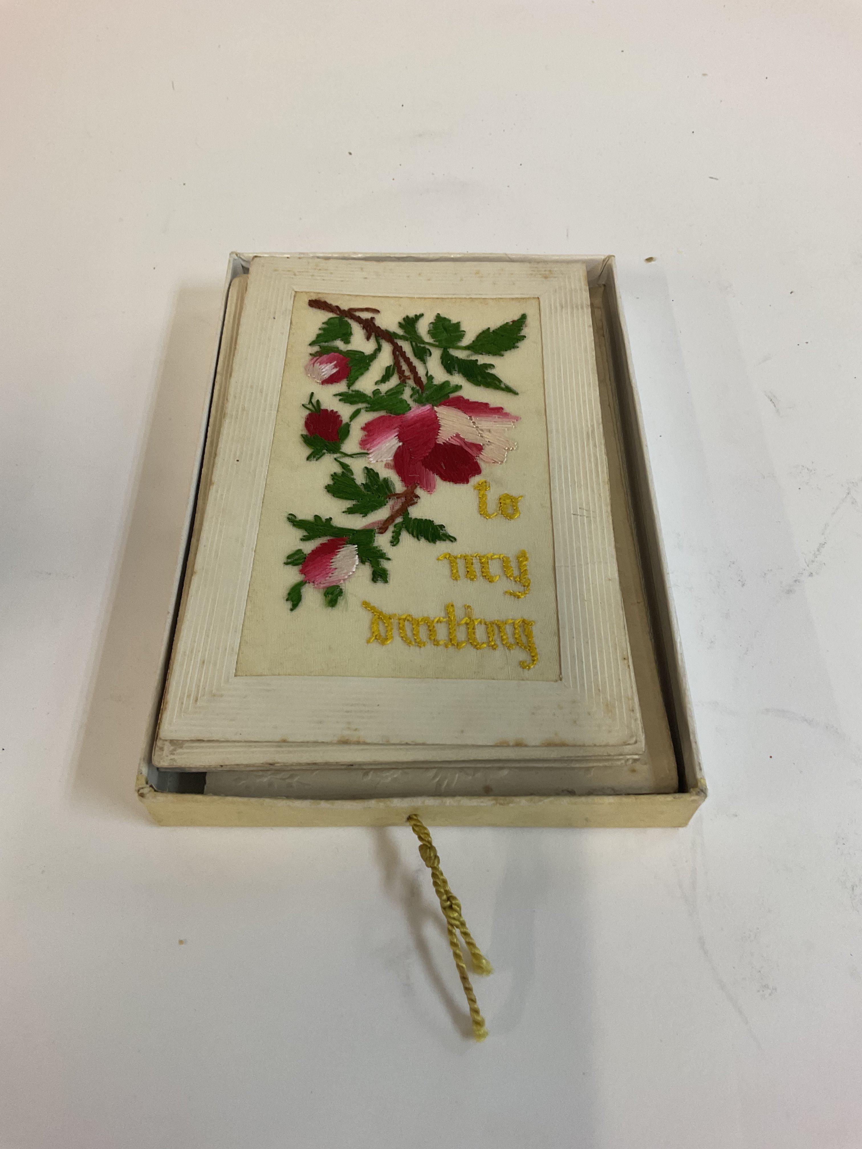 A post card album along with silk cards.