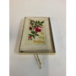 A post card album along with silk cards.