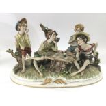 A Capodimonte figural group of boys playing cards,