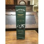 A bottle of Bowmore , single malt scotch whisky ,