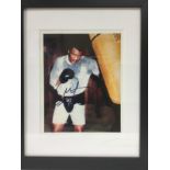 A framed and signed print of George Foreman with C