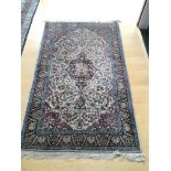 A Persian part silk hand knotted rug with a centra