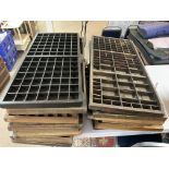 A large collection of printing trays.