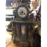 A French gilt mantle clock the top surmounted with birds inset with porcelain panels 50 cm .