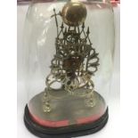 A skeleton clock under a glass dome, approx total