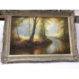 A framed oil painting of a river and woodland pain
