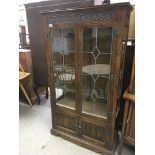 A pair of Oak display cabinets with lead light gla