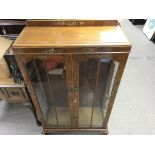 A lacquer cabinet featuring oriental style artwork