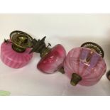 Three Victorian coloured glass oil lamp fonts .