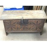 A small chest with a carved symmetrical pattern de