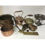 A collection of brass and copper ware kettles meas