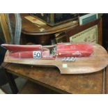 A model of a vintage motorboat in Ferrari livery, approx length 76cm. Shipping category D.