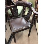 A Victorian carved corner chair on turned legs .