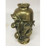 A Japanese late 19th Century brass vase with raise