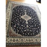 A large Persian hand knotted rug with a vivid deep