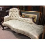 A Victorian mahogany chaise longue the carved top