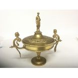 A Neo Classical gilt metal urn the lid with a rais