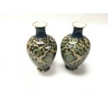 A pair of vases. Approximately 16cm tall. Damage t