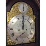 A walnut long case clock the brass dial with secon