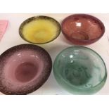 A collection of four art glass shallow bowls.
