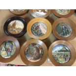 A collection of 18 framed pot lids .