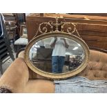 A oval shaped gilt framed mirror, approx 93cm.