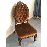 A Victorian carved walnut ladies chair with an ova