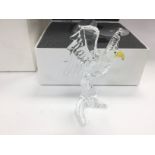 A boxed Swarovski figure of an eagle. Shipping cat