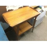 A mid 20th Century teak tea trolley. Shipping cate