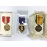 Three American medals comprising a purple heart, V