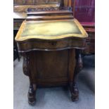 A Victorian walnut Davenport the serpentine front