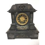 A Victorian black slate mantel clock with raised g