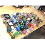 A large collection of various glass paperweights i