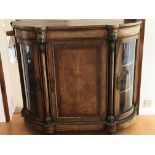 A Victorian inlaid walnut credenza. With bowed gla