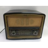 A Bush bakelite radio. Approx width 31cm. Shipping