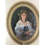 An oval framed portrait of of a young lady signed