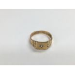 A 9ct gold ring set with a small diamond, approx 3