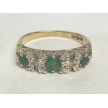 An emerald and diamond 9ct gold ring , size L. 3.1