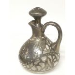 A white metal mounted glass jug with ornate folate