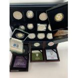 A collection of cased silver and white metal coins